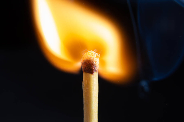 Match at just the right moment to burn. Very close photography with the black background - Photo, Image