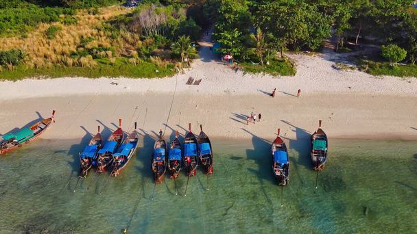 Amazing overhead aerial view of Long Tail Boats on a Thailand Beach Shoreline. - Photo, Image