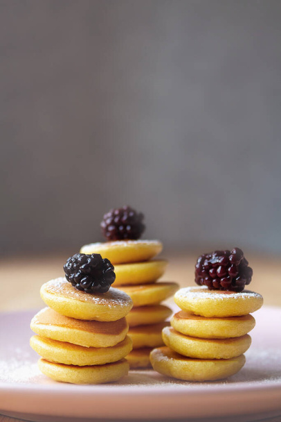 Close up of tiny pancakes with blackberries. - 写真・画像