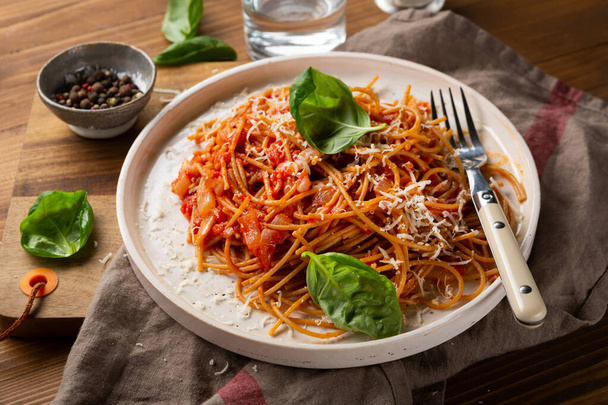Whole wheat spaghetti on white plate - Photo, image