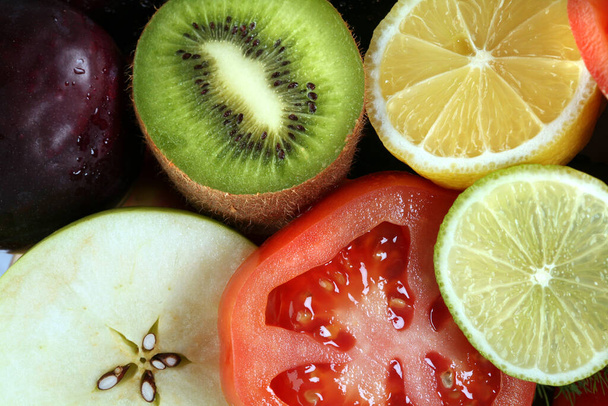 close-up of assorted cut ripe fruits and vegetables studio - Foto, Imagen