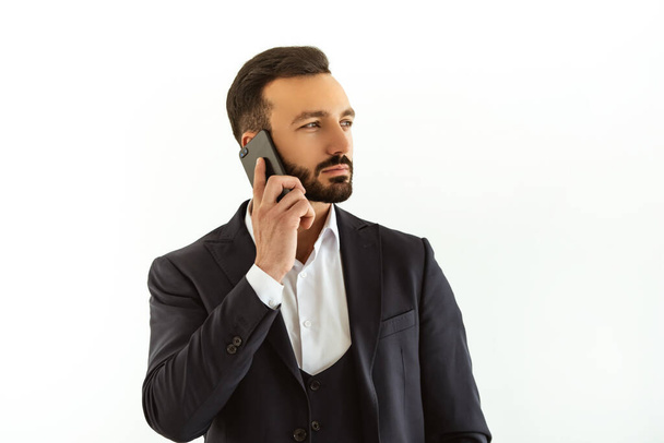 The businessman phones on the white background - Foto, Bild