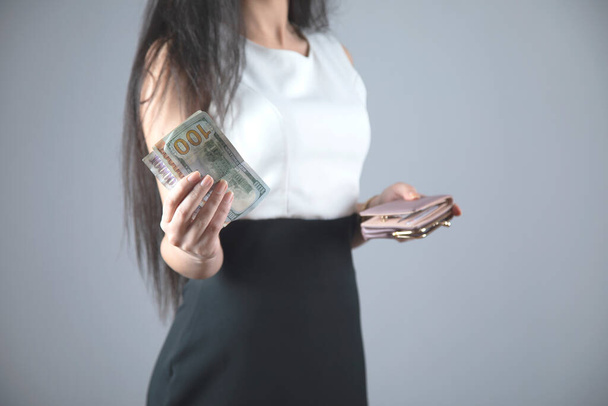 woman hand money and wallet on grey background - Фото, зображення