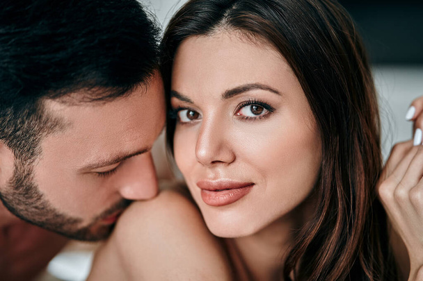 The attractive man kissing woman shoulder - Foto, immagini