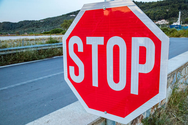 Stop sign on a suburb empty road. - Valokuva, kuva