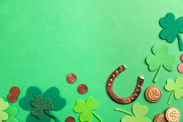 Flat lay composition with horseshoe on green background, space for text. St. Patrick's Day celebration - Photo, image