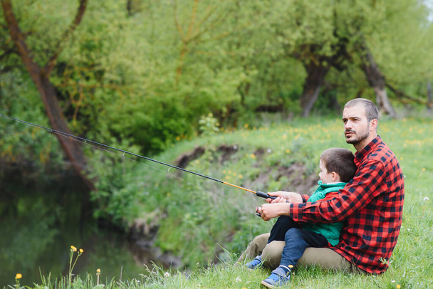 Father and son fishing together - 写真・画像
