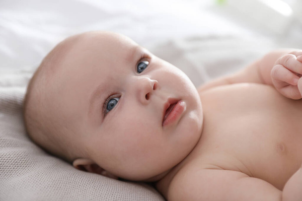 Cute little baby lying on bed, closeup - Photo, Image