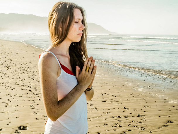 woman meditating at sandy beach - Photo, Image