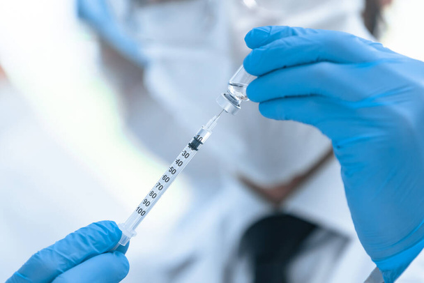 close up. group of scientists conducting trials of the new vaccine . - Photo, Image
