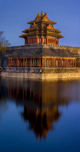 Northwestern tower of the Forbidden City Palace Museum reflecting in the water moat during still night in Beijing, China - Fotó, kép