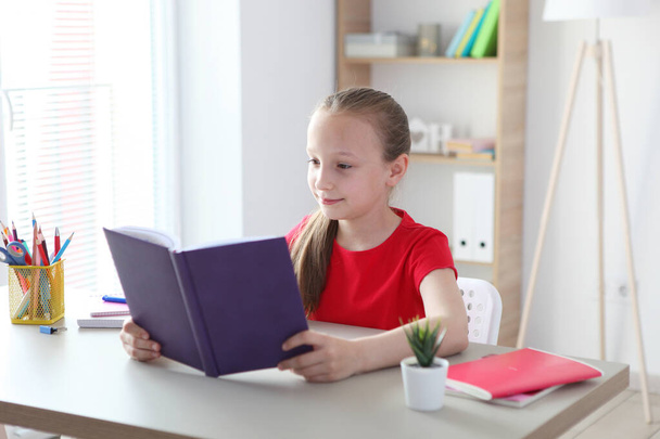 little girl reads a book at home - Foto, Imagem