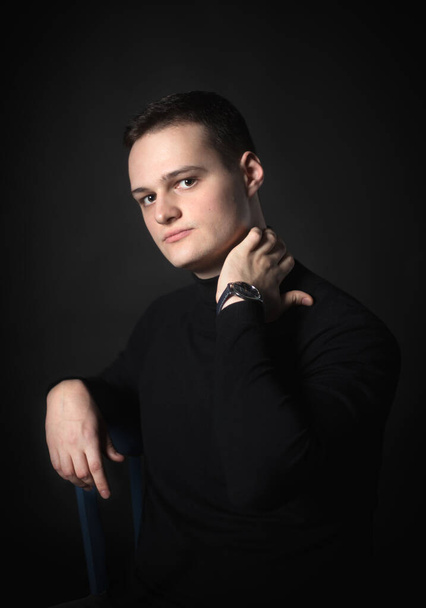 Portrait of an attractive man in the studio on a black background. - Photo, Image