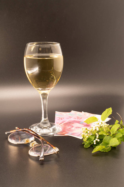 Glass of wine, banknotes, glasses, white flower, profitable order, copywriter, freelancer, spring - Foto, Imagen