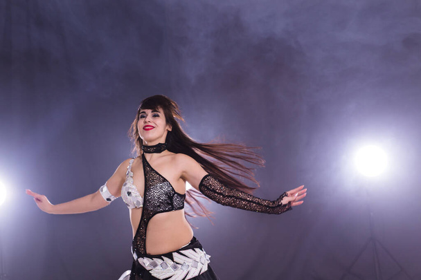 Spirituality dance. Beautiful sexy woman with luxury glossy eastern make-up dancing tribal fusion. Belly dance. - Foto, Bild