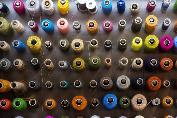 background of spools of colored thread - 写真・画像