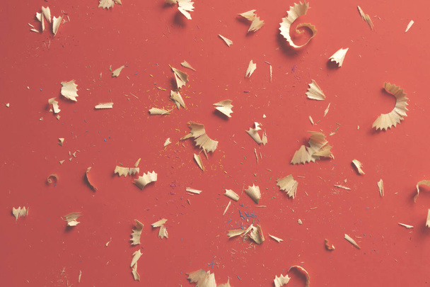 color pencil shavings on a red background - Foto, immagini