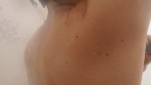 Woman shaves her armpits with a razor. Slow motion video in bathroom. Close up video of wet skin. - Footage, Video