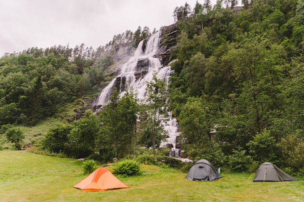 Tvinde Táborové stany na pozadí vodopádu Tvindefossen v Norsku u Voss. Kemp v norských fjordech. - Fotografie, Obrázek