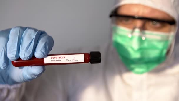 4K, Healthcare to aid recovery from COVID-19. Scientist wear protective suit and surgical gloves with a negative coronavirus blood sample test. Scientist doctor biohazard protection clothing-Dan - Filmati, video