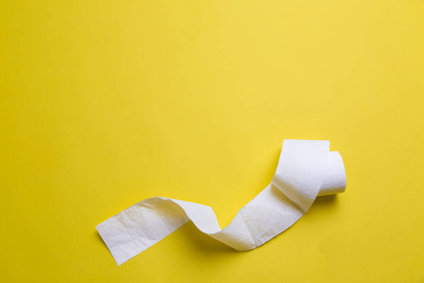 toilet paper rolls on yellow background. everyday objects in copy space. shortage of raw materials during period of coronavirus. a popular product on market. delivery of goods for house - 写真・画像