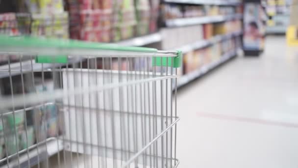 Grocery cart Moving through Aisle with blurry background shot, new normal life, stock up on food, shopping items  supply, SLOW MOTION - Footage, Video