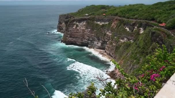 A rocky island in the middle of a body of water at Uluwatu temple - Footage, Video