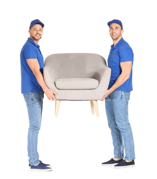 Loaders carrying furniture against white background - Foto, immagini