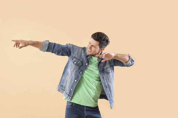 Handsome young man dancing against color background - Photo, Image
