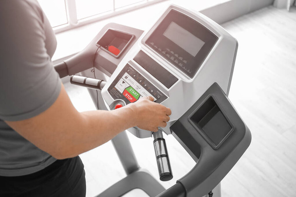 Young man training on treadmill in gym - Photo, Image