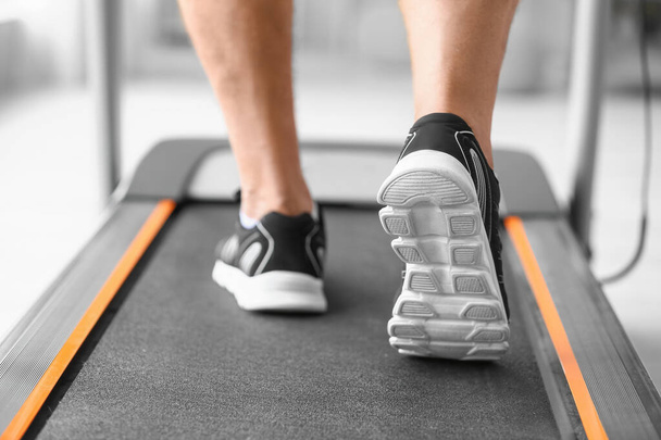 Senior man training on treadmill in gym, closeup - Photo, Image