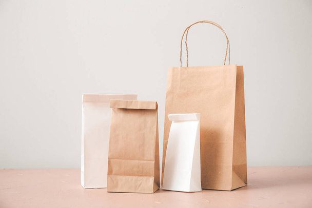 Paper bags on table against light background - Photo, Image