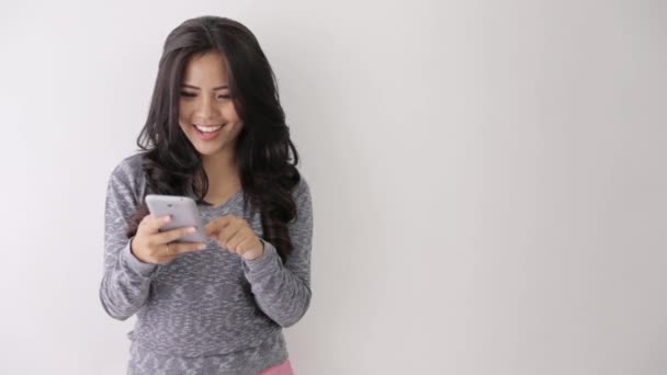young asian woman using smartphone - Materiał filmowy, wideo