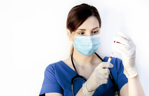 doctor woman wearing medical gloves, mask and holding injection, coronavirus   - Фото, изображение