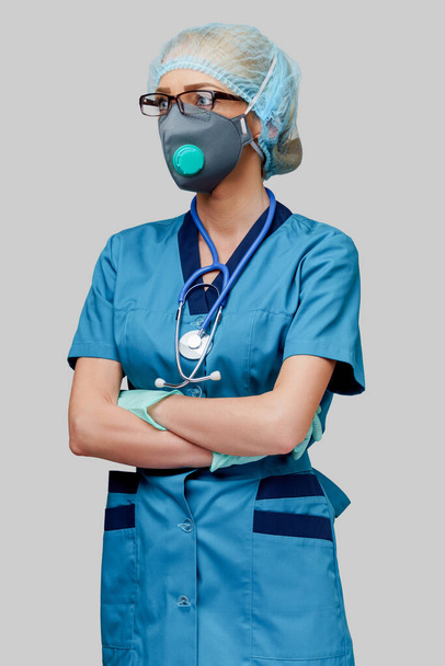 female doctor with stethoscope wearing protective mask and latex gloves over light grey background - Photo, Image