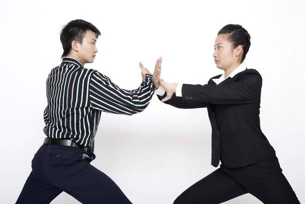 Businessman and businesswoman practising martial arts - Foto, imagen