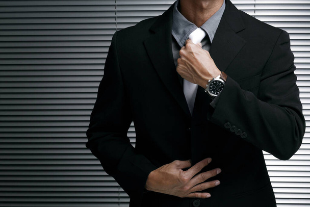 Businessman adjusting his tie - Foto, Bild