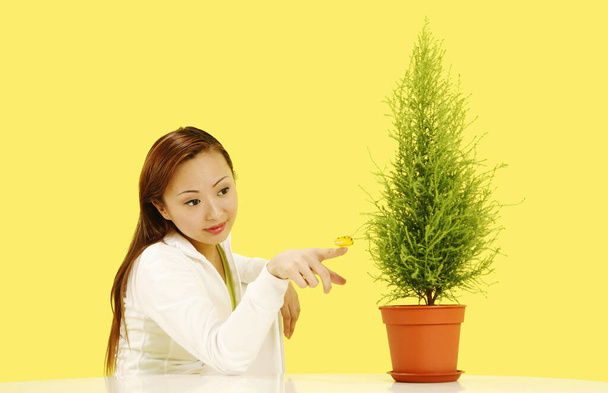 Woman playing with plant decoration - Foto, immagini