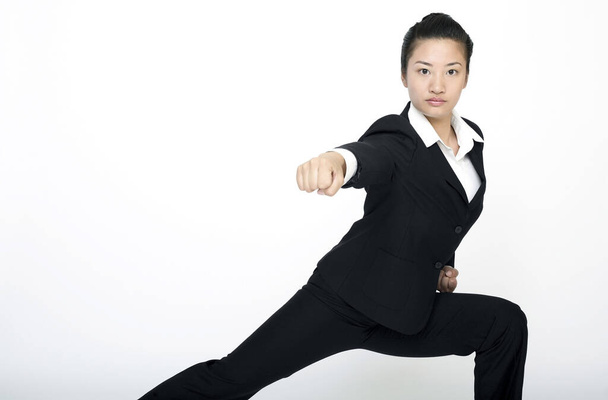 Businesswoman practising martial arts - Foto, afbeelding