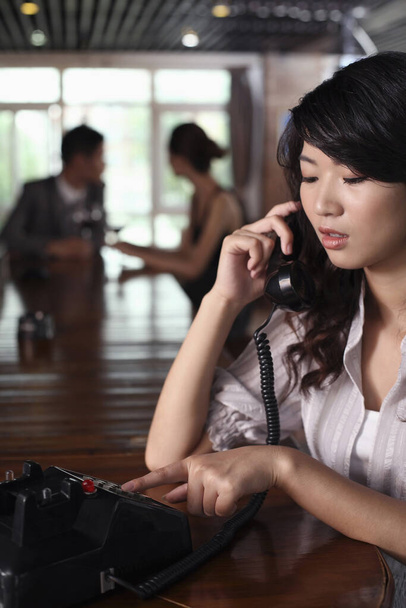 Businesswoman making a phone call using retro telephone - Foto, Imagem