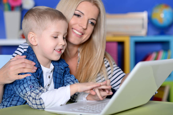 mother and son using modern laptop - Фото, зображення