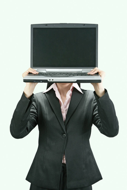 Businesswoman holding up a laptop - Φωτογραφία, εικόνα