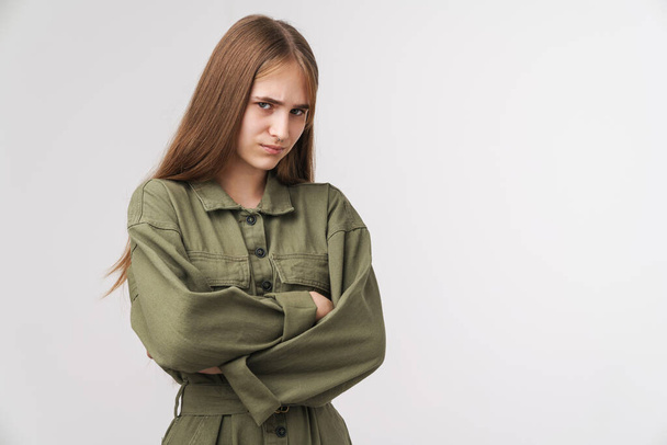 Photo of displeased young woman looking at camera with hands crossed isolated over white background - Фото, зображення