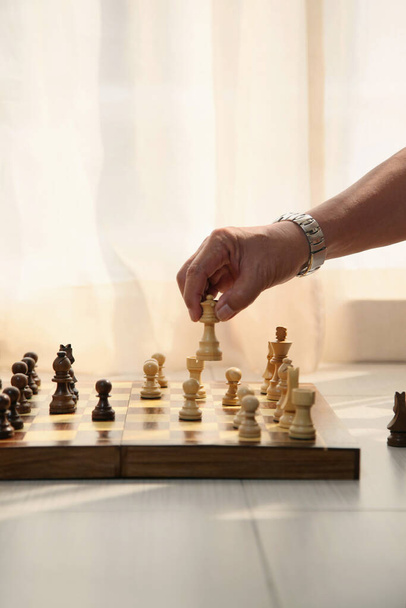 Man's hand moving a chess piece - Фото, зображення