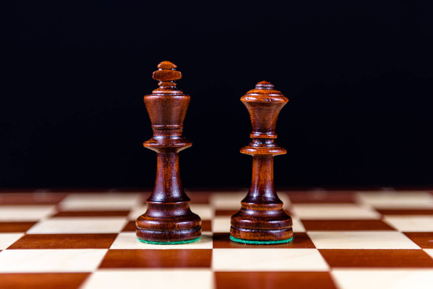black chess king and Queen on a chessboard on a black background - Foto, Imagem