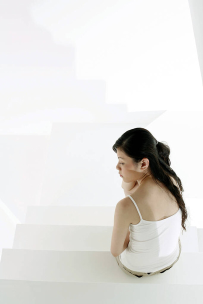 Sad woman sitting on the staircase - Foto, immagini