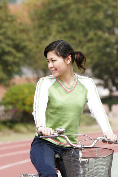 Girl riding on a bicycle. - Photo, image
