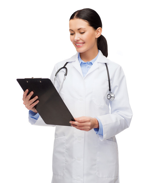 Smiling female doctor with clipboard - Photo, image