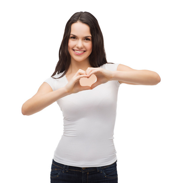 Smiling girl showing heart with hands - Foto, imagen
