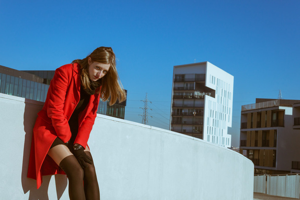 Beautiful girl posing with red coat - Photo, Image